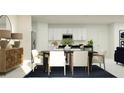 Open-concept dining area showcases a modern table setting and stylish decor at 2278 Blue Grosbeak Pl, Wimauma, FL 33598
