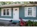 Inviting front entrance with a white door, decorative windows, and freshly planted garden at 2616 47Th N Ave, St Petersburg, FL 33714