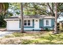 Charming single-story home with blue siding, white trim, and a well-maintained front yard at 2616 47Th N Ave, St Petersburg, FL 33714