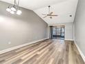 Spacious living room with vaulted ceilings, new floors, and sliding glass doors to the patio at 2696 60Th Avenue W Ter # 10, Bradenton, FL 34207