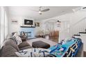 Spacious living room with modern ceiling fan, beautiful hardwood floors, and fireplace at 2700 10Th W St, Palmetto, FL 34221