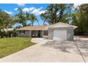 Charming single-story home with a brick facade, well-maintained lawn, and attached one car garage at 3119 W North St, Tampa, FL 33614