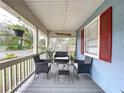Inviting covered front porch with wicker furniture, decorative accents, and a relaxing outdoor space at 3213 E Genesee St, Tampa, FL 33610