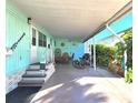 Spacious carport featuring outdoor seating and ample room for parking and leisure, ideal for relaxed living at 34483 Cactus N Dr, Pinellas Park, FL 33781