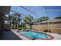 Enclosed pool with screen cage to keep debris out, accompanied by hot tub and blue water on a sunny day at 4222 Trumpworth Ct, Valrico, FL 33596