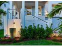 Elegant front yard with lush landscaping, a tranquil fountain, and a charming staircase leading to the porch at 509 Buckingham E Ave, Oldsmar, FL 34677