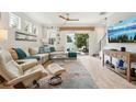 Bright and airy living room featuring stylish decor, comfortable seating and glass sliding doors to the patio at 513 Harbor Springs Dr, Palm Harbor, FL 34683