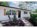 Charming front entrance with accent chairs, decorative tile, and colorful landscaping at 5698 26Th N Ave, St Petersburg, FL 33710