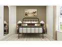 Inviting bedroom with a stylish metal bed frame, neutral decor, and bright natural light at 6462 Propel Run, New Port Richey, FL 34655