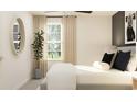 Bright and airy main bedroom featuring contemporary decor, a round mirror, and natural light at 6480 Propel Run, New Port Richey, FL 34655