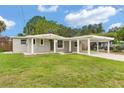 Charming single-story home with a well-maintained lawn and covered parking at 6612 W Chelsea St, Tampa, FL 33634