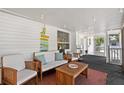 Inviting covered patio featuring cozy seating, string lights, and coastal decor, perfect for relaxing outdoors at 7201 5Th N Ave, St Petersburg, FL 33710