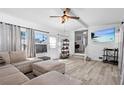 Bright and airy living room with modern flooring, comfortable seating, and ample natural light at 7201 5Th N Ave, St Petersburg, FL 33710