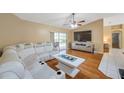 Comfortable living room with a vaulted ceiling, hardwood floors, and sliding door access to pool at 815 Sandy Trail Pl, Brandon, FL 33511
