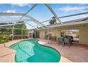 Inviting in-ground pool surrounded by a screened enclosure, perfect for relaxation at 815 Sandy Trail Pl, Brandon, FL 33511