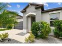 Inviting front entrance with manicured landscaping and stylish architectural details at 8772 Flourish Dr, Land O Lakes, FL 34637