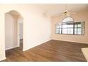 Bright living room featuring stylish wood floors, a ceiling fan, and large windows at 8812 Beeler Dr, Tampa, FL 33626