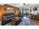 Cozy living room featuring leather furniture, rustic coffee table, and access to outdoor space at 9209 Seminole Blvd # 12, Seminole, FL 33772