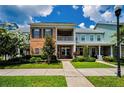Charming two-story townhome with brick facade, balcony and lush landscaping at 10035 New Parke Rd, Tampa, FL 33626