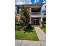 Charming two-story townhome with brick facade, balcony and well manicured lawn at 10035 New Parke Rd, Tampa, FL 33626