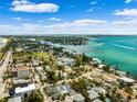 Gorgeous aerial view of a waterfront community with beaches, blue skies, and clear water on a sunny day at 106 13Th Ave, St Pete Beach, FL 33706