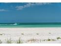 Tranquil beach scene with a motorboat gliding along the turquoise water at 1070 Eldorado Ave, Clearwater Beach, FL 33767