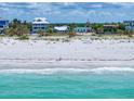 Beachfront homes line the shore with crystal blue water and a pristine sandy beach at 1070 Eldorado Ave, Clearwater Beach, FL 33767