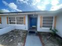 Welcoming front entrance featuring a blue front door at 11010 Salt Tree Dr, Port Richey, FL 34668