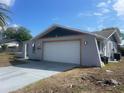View of the two-car garage on a single-story home at 11010 Salt Tree Dr, Port Richey, FL 34668