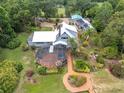 Gorgeous exterior view showcasing screened in pool area, lush landscaping, and connecting wooden walkway at 13533 Bay Lake Ln, Tampa, FL 33618