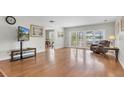 Inviting living room with hardwood floors, slider doors and view of pool at 13533 Bay Lake Ln, Tampa, FL 33618