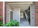 Exterior entrance showing a stairway to the second floor, neutral colors, and brick accents at 1400 Gandy N Blvd # 1504, St Petersburg, FL 33702