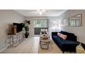 Inviting living room featuring natural light, tile floors, and a comfortable seating arrangement with stylish decor at 1400 Gandy N Blvd # 1504, St Petersburg, FL 33702