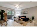 Bright living room boasts sliding glass doors to a balcony, tile floors, and neutral walls at 1400 Gandy N Blvd # 1504, St Petersburg, FL 33702