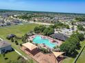 Aerial view showing community pool, clubhouse, playground and residential houses at 14614 Rannoch Moor Pl, Wimauma, FL 33598