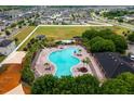 Aerial view showcasing community pool, playground, clubhouse, and surrounding neighborhood at 14614 Rannoch Moor Pl, Wimauma, FL 33598