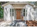 Close-up of the home's front door, framed by windows and supported by a porch at 1608 E Linden Ave, Tampa, FL 33604