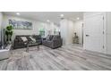Inviting living room with wood floors, two sofas, a rug, and modern decor at 1608 E Linden Ave, Tampa, FL 33604