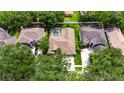 Aerial view of a home with a screened pool and well-maintained landscaping at 17711 Hampshire Oak Dr, Tampa, FL 33647