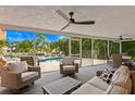 Covered patio featuring ample seating overlooking the pool and spa with tropical landscaping and water views at 1960 Montana Ne Ave, St Petersburg, FL 33703