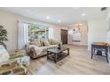 Bright living room featuring a comfortable couch, stylish decor, and lots of natural light at 2724 Ashwood Ct, Clearwater, FL 33761