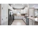 Modern kitchen with stainless steel appliances, white cabinetry, and a functional layout at 29524 Zupetta Ln, Wesley Chapel, FL 33543