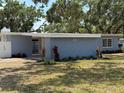 Cozy home featuring fresh landscaping with vibrant red flowers beneath the house number at 3000 58Th S Ave, St Petersburg, FL 33712