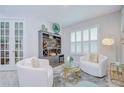 Airy living area boasts elegant furniture, plantation shutters, and a chic bar setup at 33518 Castaway Loop, Wesley Chapel, FL 33543