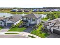Aerial view of the beautiful home backing onto a serene lake in a desirable neighborhood at 34307 Radley Way, Wesley Chapel, FL 33545