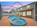 Inviting screened-in pool and spa area featuring a fountain, perfect for relaxation and entertainment at 4224 Fleewell Ct, Valrico, FL 33596