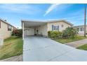 Single-story home with carport, garage, manicured landscape, and vibrant bougainvillea at 520 Canal Way, Oldsmar, FL 34677