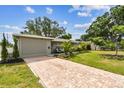 Inviting single-story home with a brick driveway and neatly landscaped front yard at 5245 18Th N St, St Petersburg, FL 33714