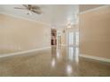 Bright living room featuring a view into the kitchen and french doors leading to the lanai at 5803 Cresthill Dr, Tampa, FL 33615