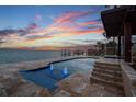 Tranquil outdoor pool area with waterfront views and illuminated fountains at 5810 Mariner St, Tampa, FL 33609